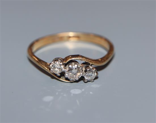 An 18ct and plat, three stone diamond crossover ring, size M.